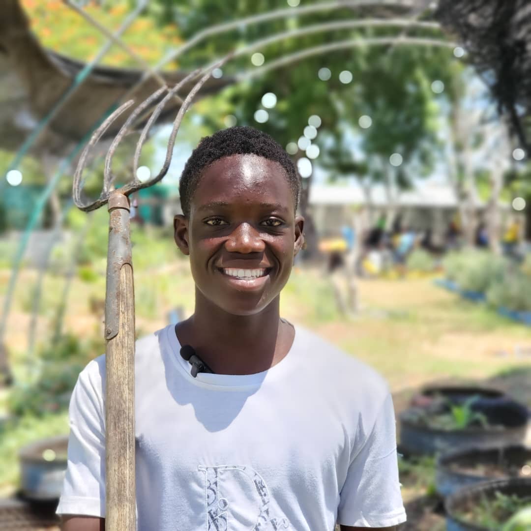 A young Haitian at work in the field with KONKRET